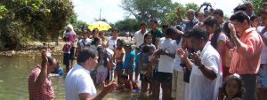 Colombian Christian missionary baptizes new Christians in a river