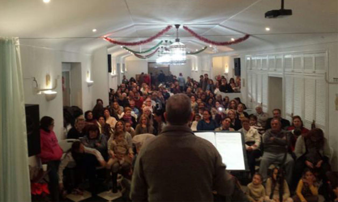 Pastor in Spain preaching to his congregation in the main hall of their church