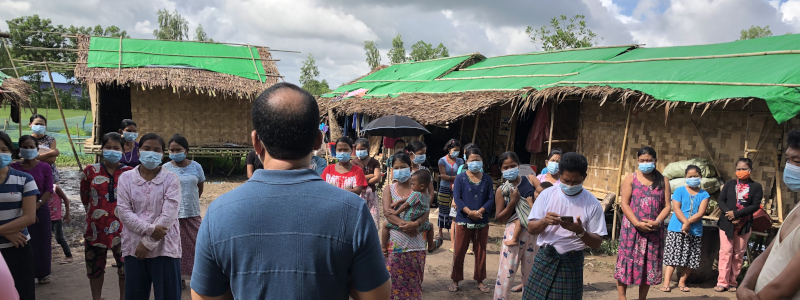 Lao women gather in front of their homes to hear the gospel proclaimed by a local Christian missionary