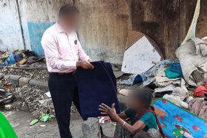 Christian missionary gives a blanket to a woman in need
