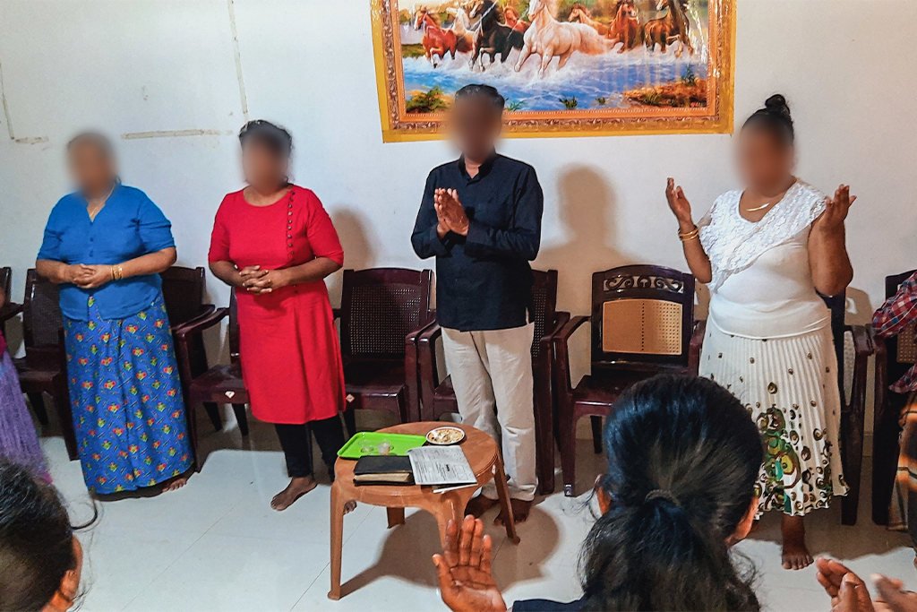 Sri Lankan Christians stand in a circle worshiping God