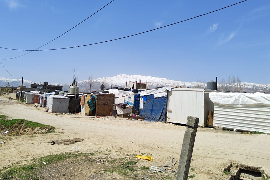 A refugee camp built from plywood, old buildings, and tarps