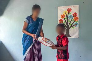 Sri Lankan Christian woman gives boy package
