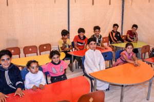 Jordanian children sitting at semicircular desks in school