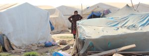 Turkish christian woman stands in a refugee camp