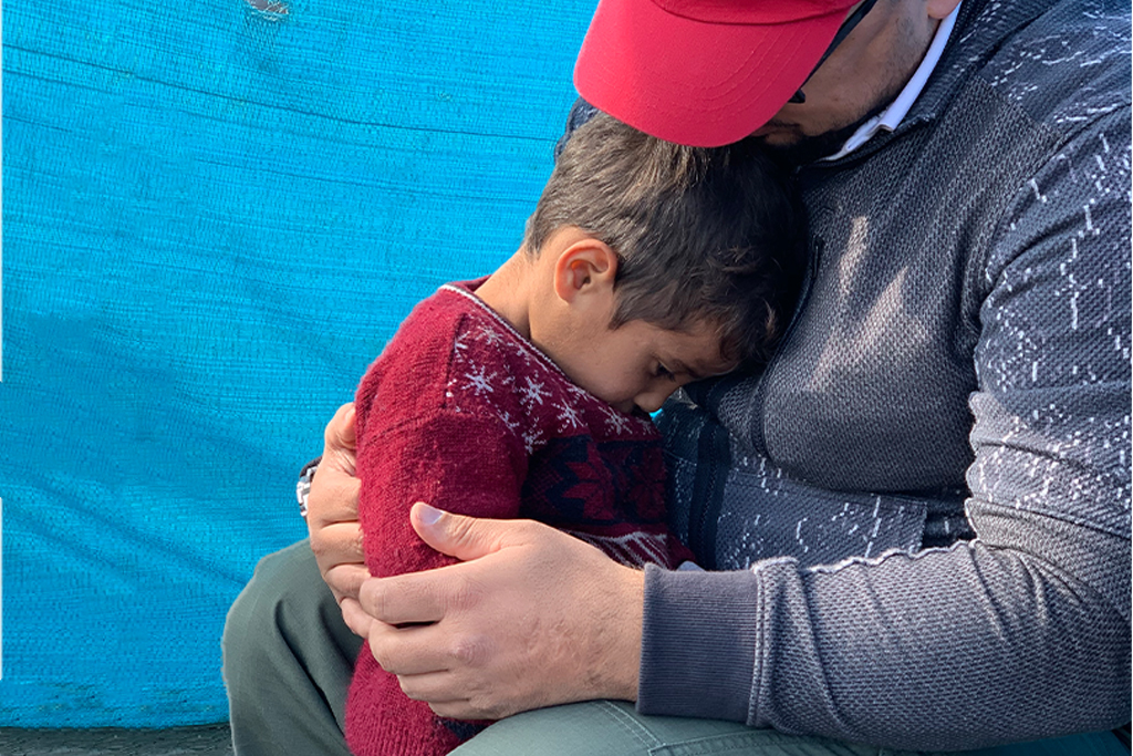 Lebanese refugee boy finds comfort in his father's arms