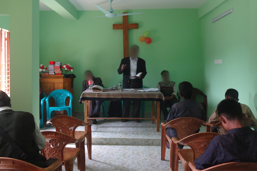 Bangladeshi pastor preaching to his small congregation