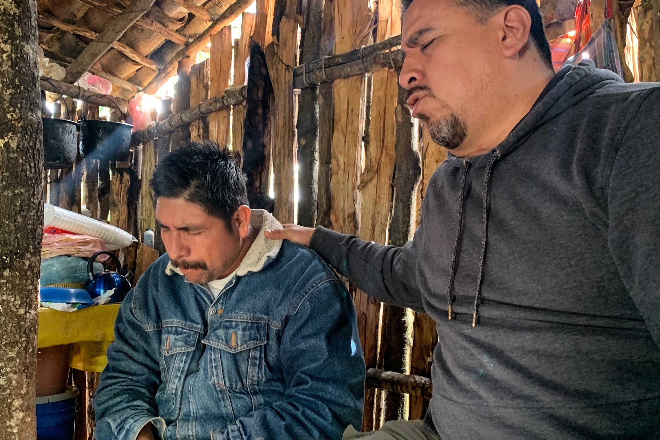 Mexican Christian Evangelist praying for a Mexican man in a shed