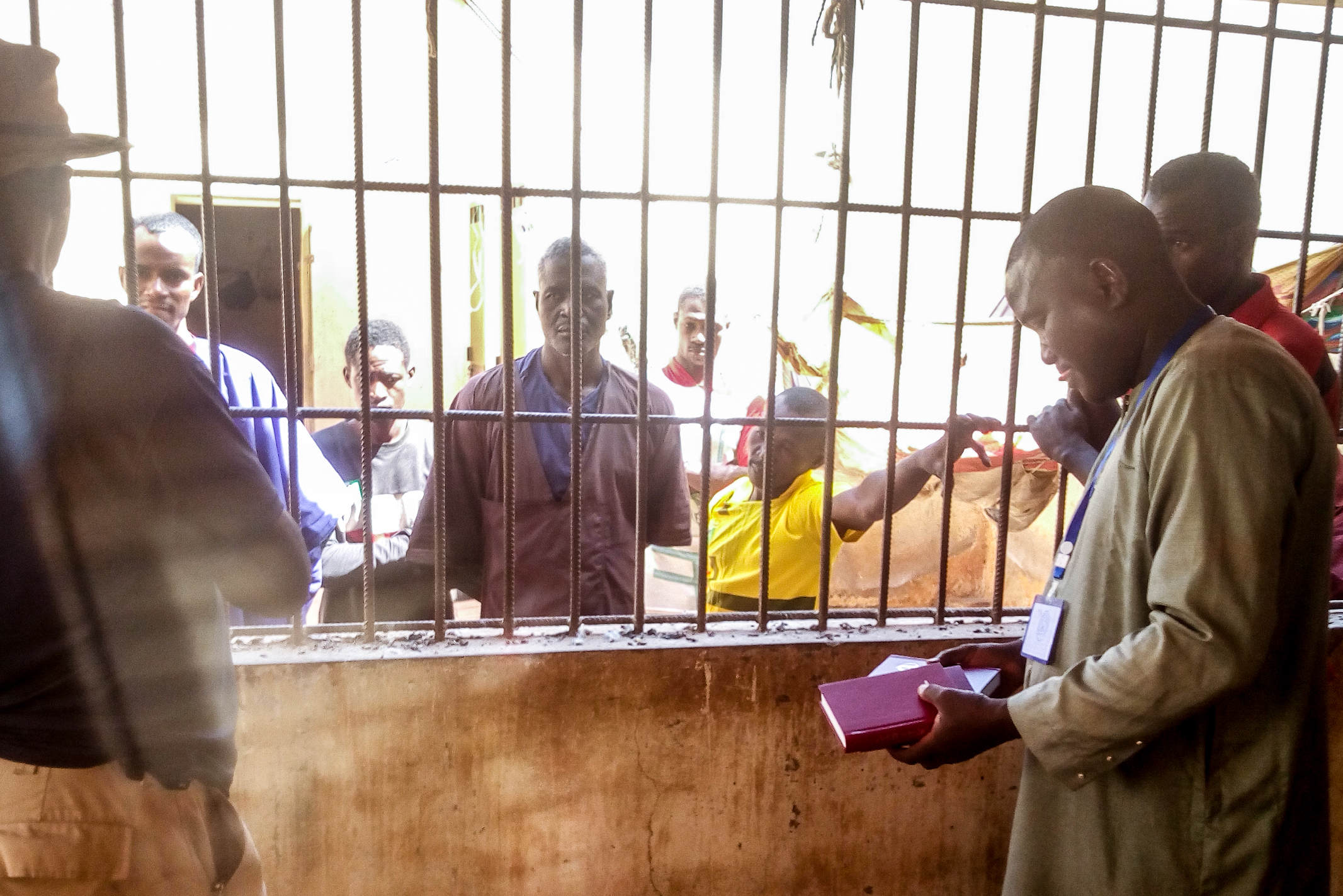 Christian missionaries in Mali passing out Bibles to inmates behind bars