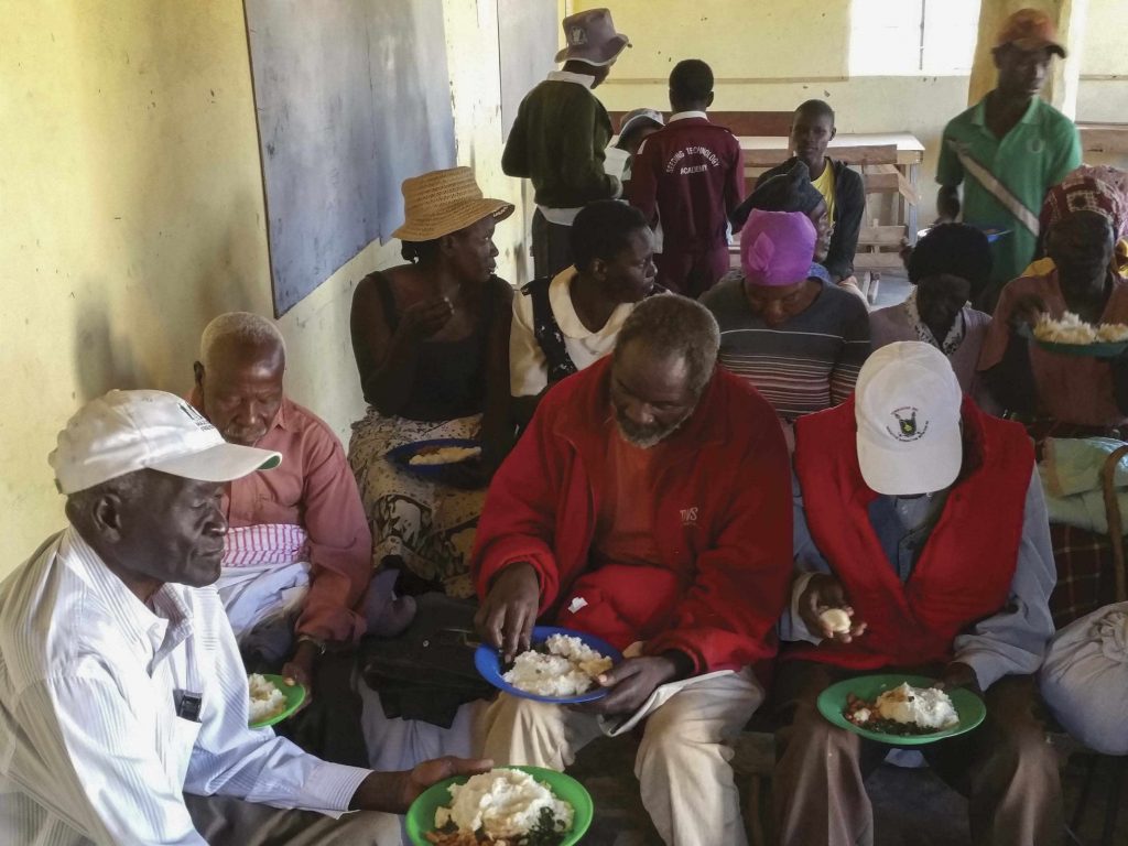 People in Africa eating a meal provided by a Christian feeding program