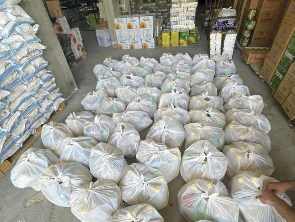 Grocery bags filled with food for refugees sitting in a warehouse