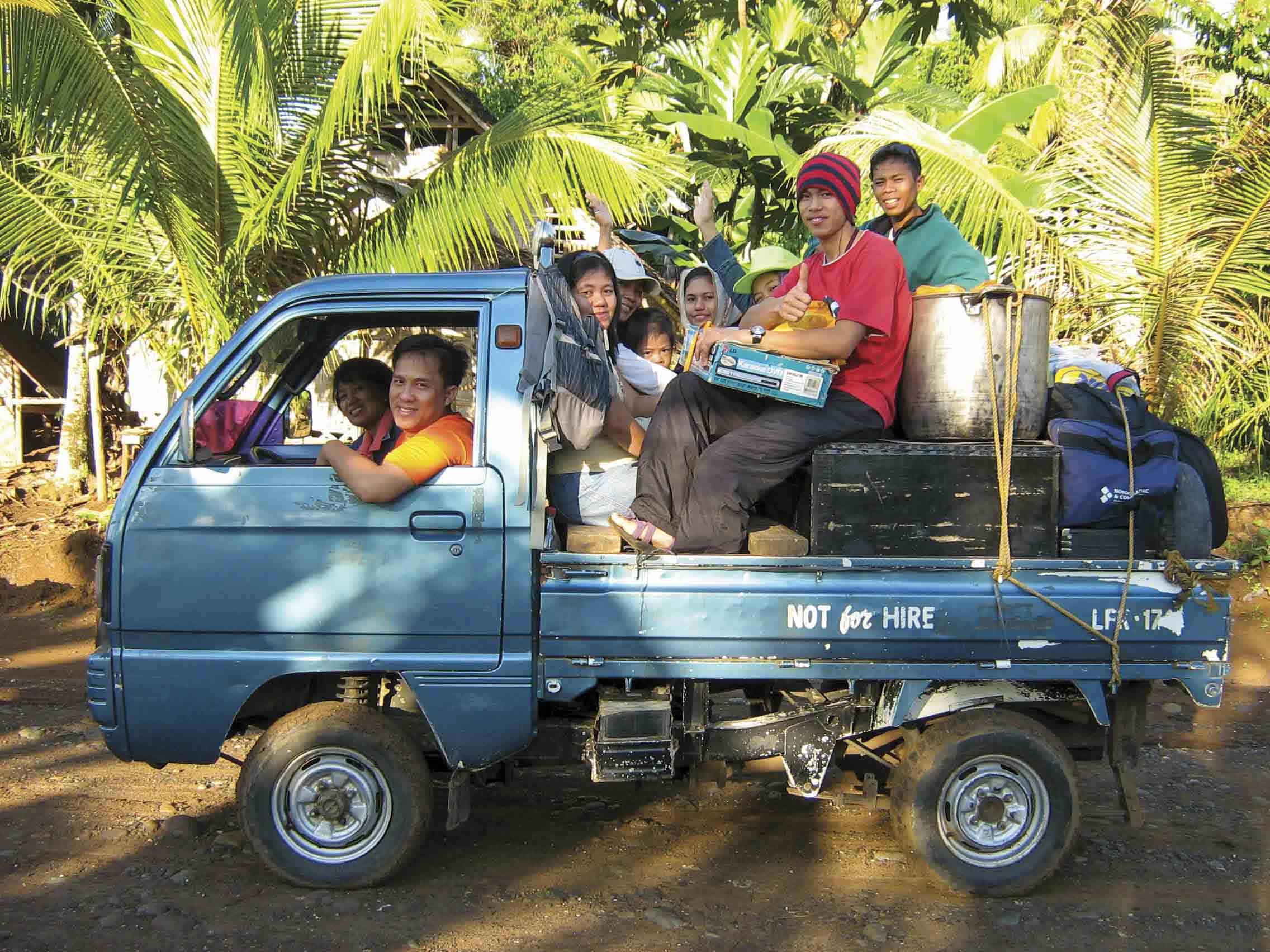 A Filipino Christian missionary in a loaded truck with his family ready to travel